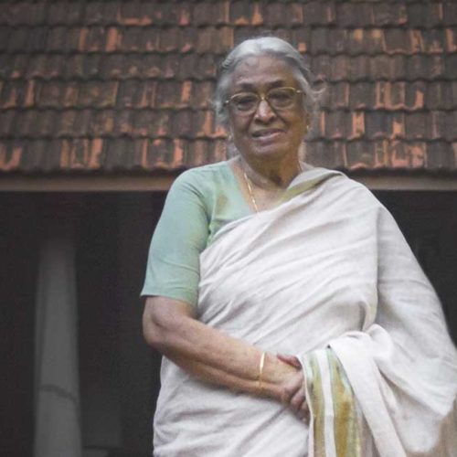 A portrait of Mrs. Meenakshi Meyyappan, proprietor of The Bangala Hotel, in the courtyard of her Karaikudi home.