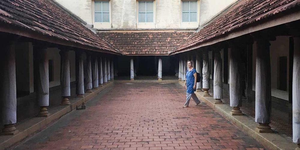 Karen enters the inner courtyard of a Chettiar mansion.