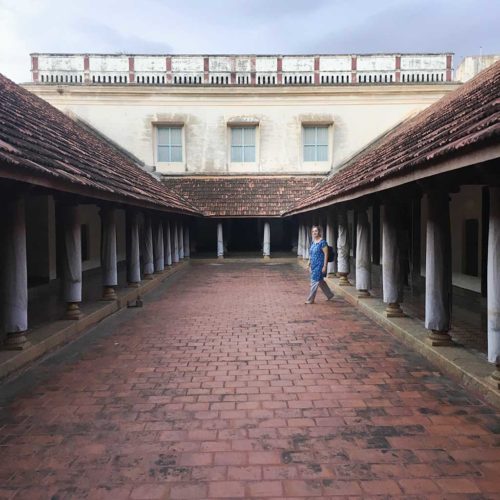 Karen enters the inner courtyard of a Chettiar mansion.