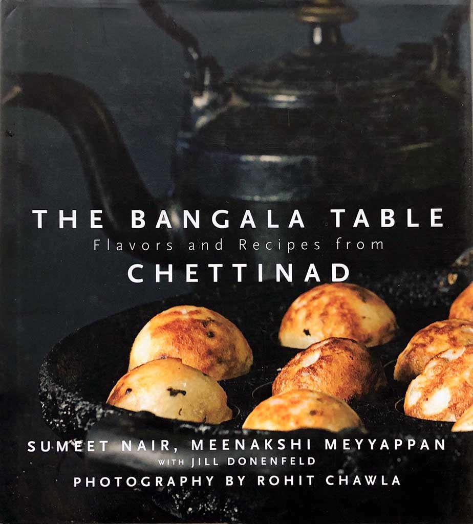 The darkly toned cover of The Bangala Table cookbook.