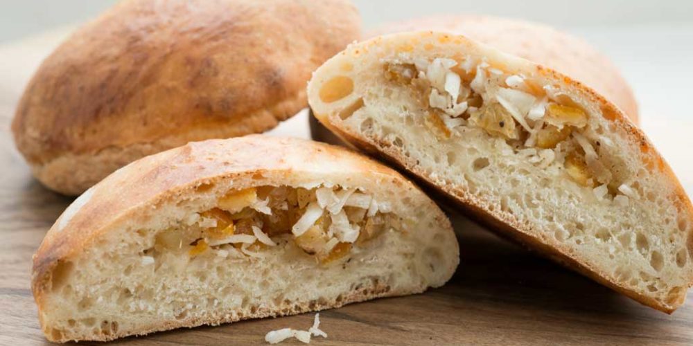 Coconut buns with candied ginger and citrus peel.