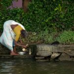 Washing brass wear along the Keralan backwaters.