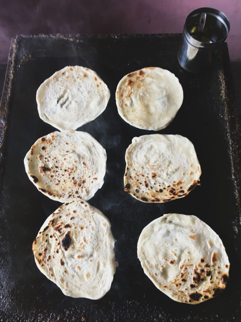 Paratha cooking on the grill.