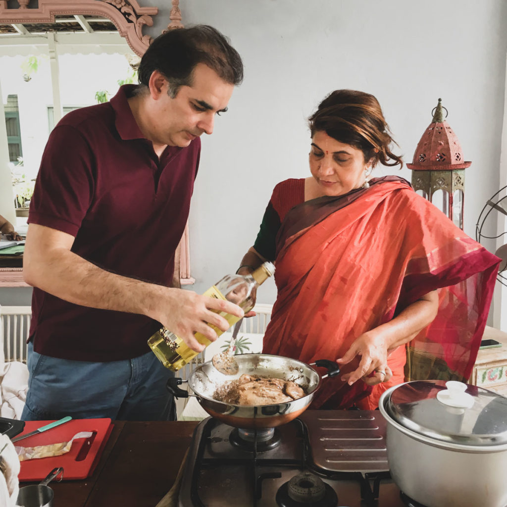 Sumeet with Anita wearing a burnt orange sari making poulet