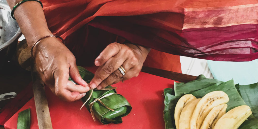 The banana and stick rice packets are tied with twine.