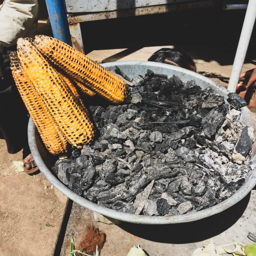 Grilled corn on charcoal.