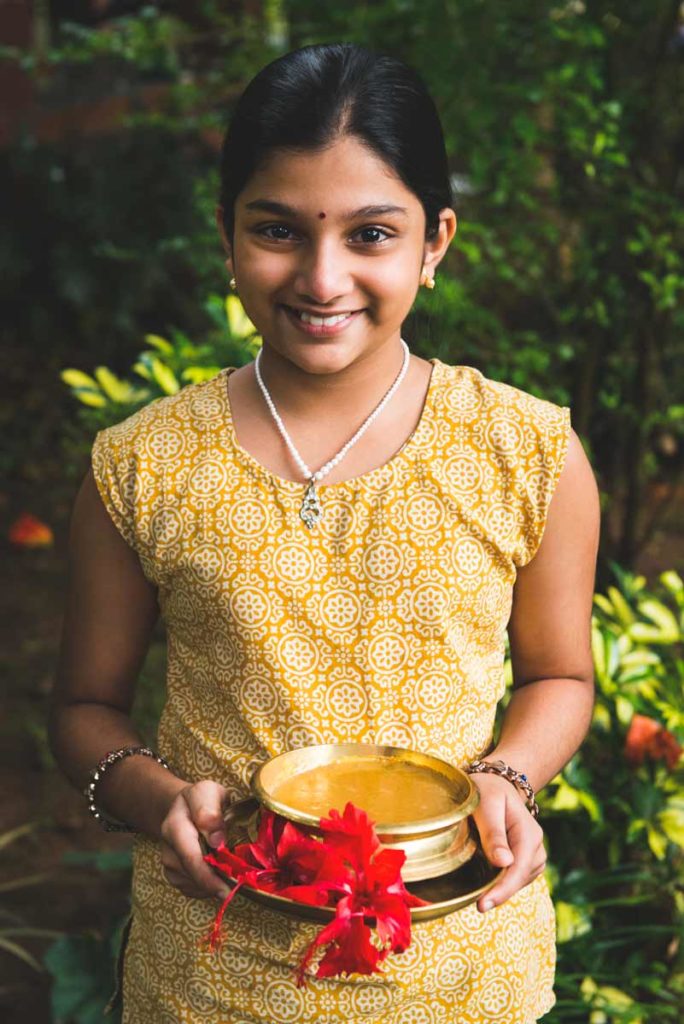 Amuu presenting payasam with ripe bananas.