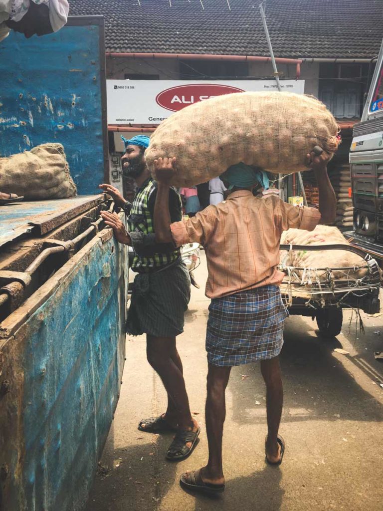 Big-Bazar-man packing-onions on his head.