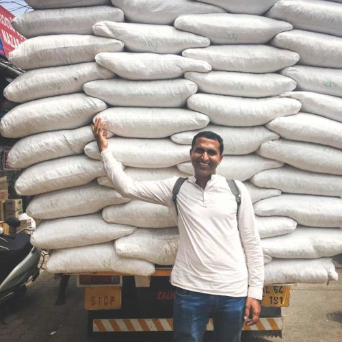 Supply truck filled with white sacks in Big Bazar Street Kozhikode