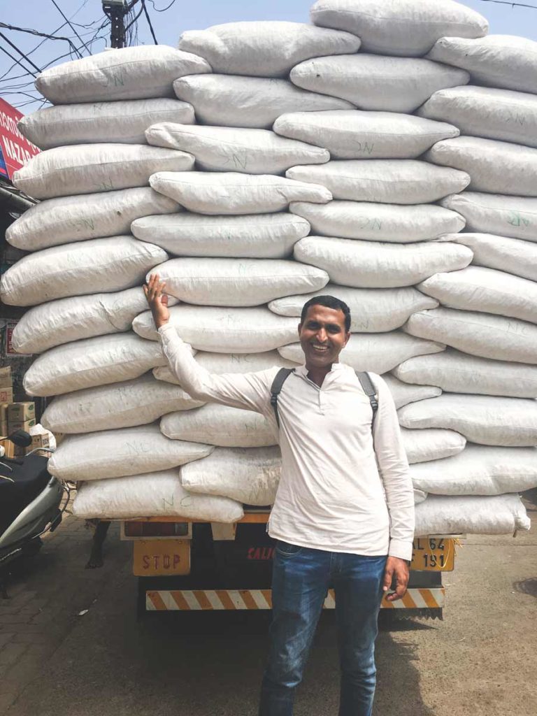 Supply truck filled with white sacks in Big Bazar Street Kozhikode