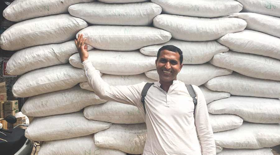 Supply truck filled with white sacks in Big Bazar Street Kozhikode