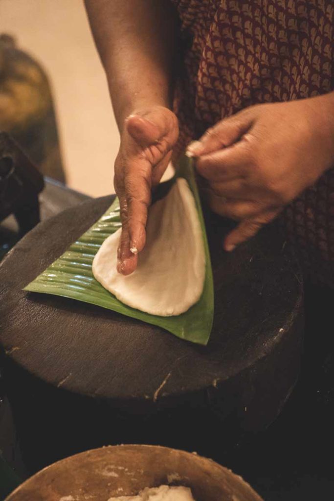 White Pathiri dough rolled out on a green banana leaf