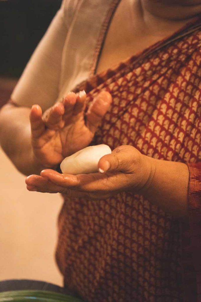 Pathiri bread dough cupped in a hand.