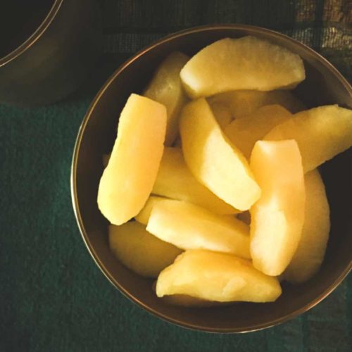 Steamed apple segments in a bowl