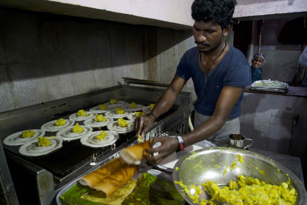 an Indian man cooking