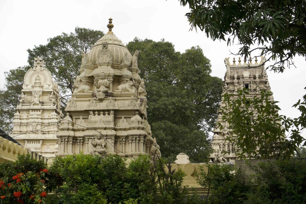 Three white marble ornately carved temples