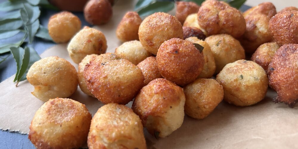 fried balls of dough on brown paper