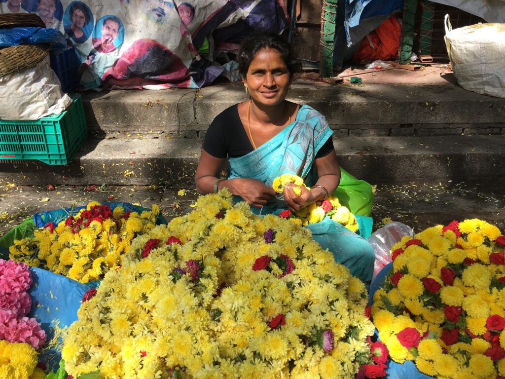 woman with a pile of yellow flowers