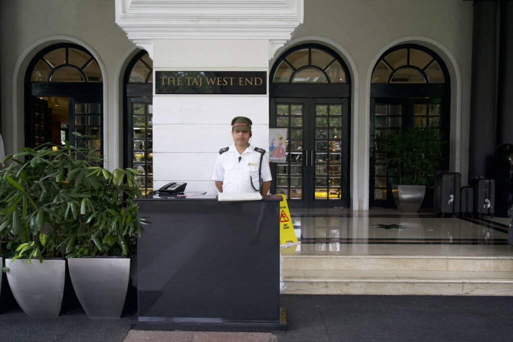 Exterior of hotel with a man in uniform